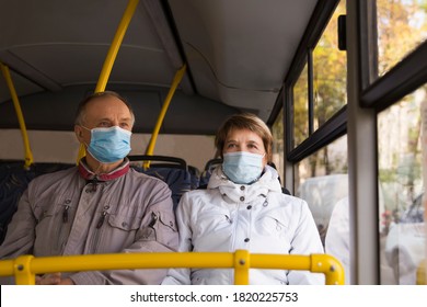 Senior Couple  Wearing Medical Face Mask Sitting In The Bus Transport. New Normal.