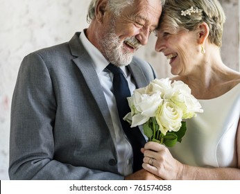 Senior Couple with White Roses Flower Bouqet - Powered by Shutterstock