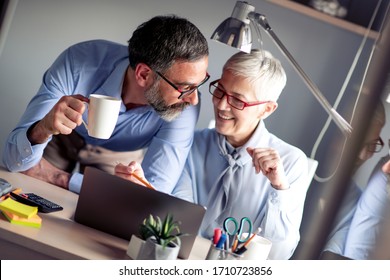 Senior Couple Working On Laptop At Home Office.