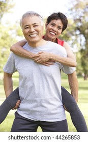 Senior Couple Working Out In Park