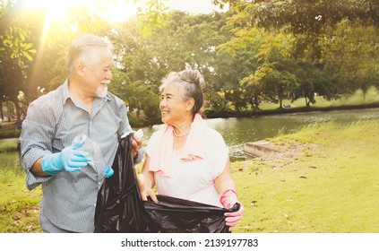 Senior couples with volunteer recreation activities collect recycled plastic bottles and put them in black bags to keep the garden area clean in preparation for disposal on the World Environment Day. - Powered by Shutterstock