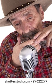 Senior Cowboy Playing The Harmonica