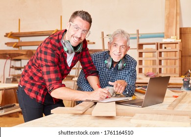 Senior craftsman and colleague work as a team in carpentry or joinery - Powered by Shutterstock