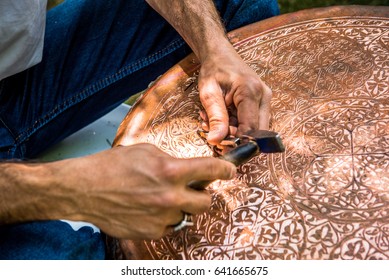 Senior Craftsman,tinsmith,working With Hammer During Hand Stamping Or Engraving Decoration Pattern On Metal Plate.Copper Master, Hands Detail Of Craftsman At Work.