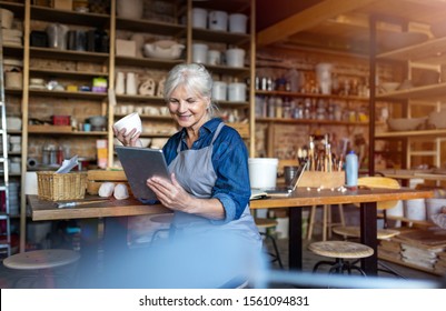 Senior craftswoman with tablet computer in art studio 
 - Powered by Shutterstock