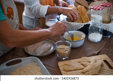 Senior And Daughter Cooking Together At Home- Grandma Showing And Teach How To Cook Fish - Have Fun And Happy Moment Indoor- Eating At The Kitchen - Mature Woman With Glasses And Retired 60s Caucasian