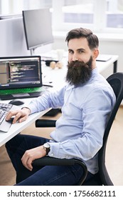 Senior Developer Working On Computer In IT Office, Sitting At Desk And Coding, Working On A Project In Software Development Company Or Technology Startup.