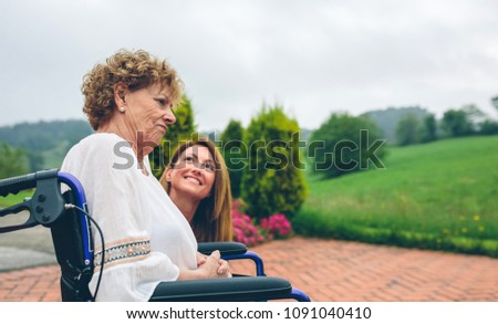 Similar – Senior dissatisfied woman in a wheelchair with her daughter