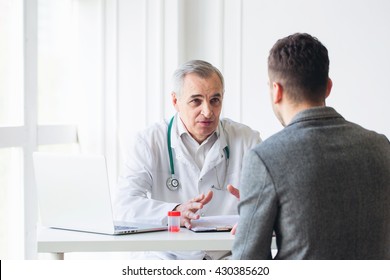 Senior doctor consults young patient - Shutterstock ID 430385620