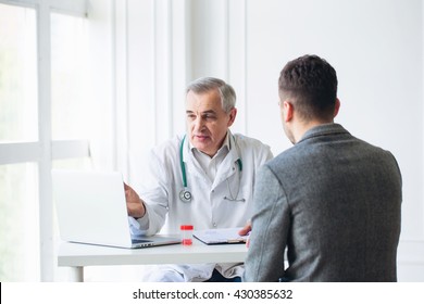 Senior Doctor Consults Young Patient