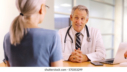 Senior Doctor Discussing Health Concerns With Elderly Woman