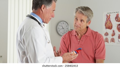Senior Doctor Explaining Heart To Elderly Patient