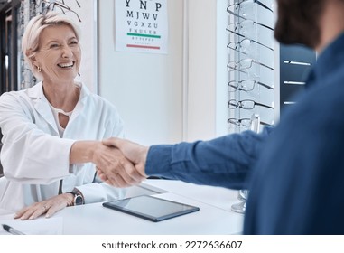 Senior doctor, handshake or man consulting for eyesight advice at optometrist or ophthalmologist with medical aid. Happy customer shaking hands with a trusted optician after checking vision health - Powered by Shutterstock