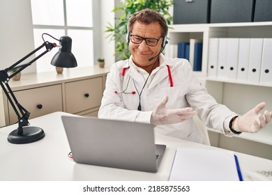 Senior Doctor Man Working On Online Appointment Inviting To Enter Smiling Natural With Open Hand 