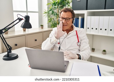 Senior Doctor Man Working On Online Appointment Hand On Mouth Telling Secret Rumor, Whispering Malicious Talk Conversation 