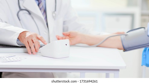 Senior Doctor Measure Blood Pressure For Asian Woman To Check Her Condition