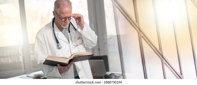 Senior Doctor Reading A Textbook In Clinic; Multiple Exposure