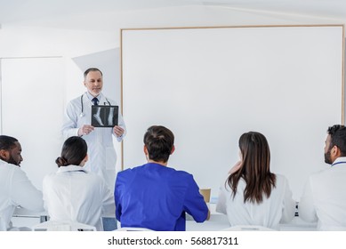 Senior Doctor Teaching Interns At Clinic