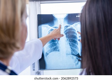 Senior Doctor Woman Teaching Doctor Student Woman. How To Analyze The X-ray Film. Radiology Department.