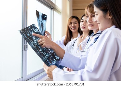 Senior Doctor Woman Teaching Doctor Student Woman. How To Analyze The X-ray Film. Radiology Department.