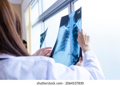 Senior Doctor Woman Teaching Doctor Student Woman. How To Analyze The X-ray Film. Radiology Department.