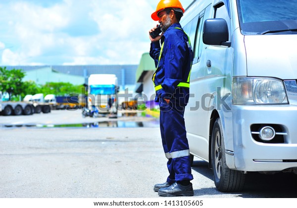 Senior driver using walkie-talkie to\
operation for let the van go out to get the\
job.
