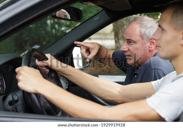 senior
driving instructor giving instructions to
student