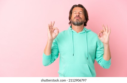 Senior Dutch Man Isolated On Pink Background In Zen Pose