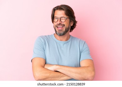 Senior dutch man isolated on pink background With glasses and happy expression - Powered by Shutterstock