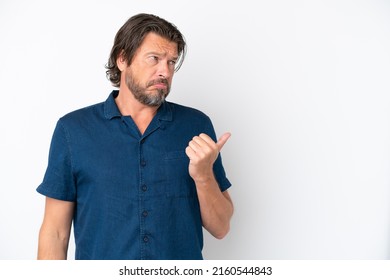 Senior dutch man isolated on white background unhappy and pointing to the side