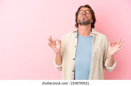 Senior Dutch Man Isolated On Pink Background In Zen Pose