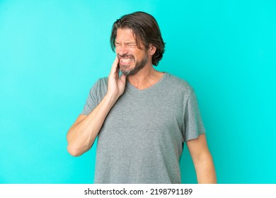 Senior Dutch Man Isolated On Blue Background With Toothache