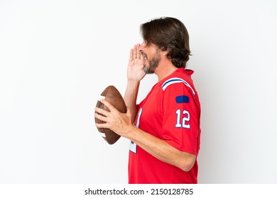 Senior dutch man playing rugby isolated on white background shouting with mouth wide open to the side