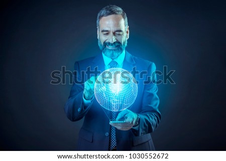 Senior elderly business man projecting the globe from his phone, choosing his next travel destination