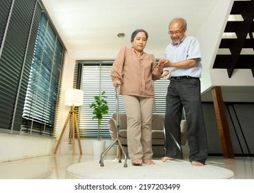 Senior Elderly Couple help support together after retirement, Husband wife person take care each other walk with walker device. Asian grandparent need staff to walk sit difficult, copy space