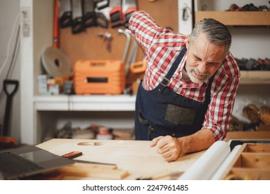 senior elderly engineer worker back pain muscle cramp from hard working prolonged standing at work - Powered by Shutterstock