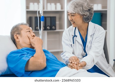 Senior elderly male patient and asian people mature woman doctor, showcasing importance of healthcare expertise and patient support. caring senior doctor assisting elderly patient in hospital bed - Powered by Shutterstock