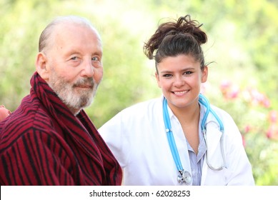 Senior Elderly Man With Nurse, Dr, Doctor Or Medical Assistant At Home