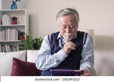 senior elderly man sitting and using internet with happy and smile on tablet technology and healthcare, retirement lifestyle concept