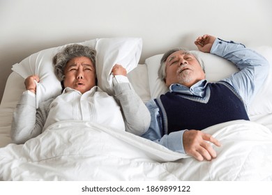 Senior elderly man sleeping and snoring on the bed with white blanket, pillow in the bedroom at home. Retirement and health care concept - Powered by Shutterstock