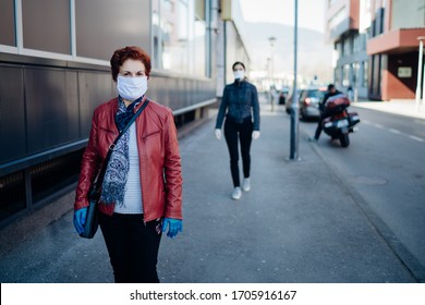 Senior Elderly Woman With Protective Cloth Face Mask And Gloves.
Coronavirus COVID-19 Outbreak Elder Disease Infection Protection.
Retired Grandmother Walking Outside Alone.Social Distancing Practice