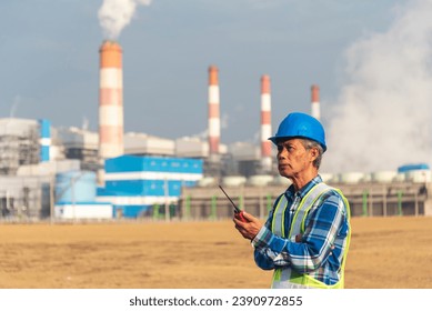 Senior Electrician engineer man hand holding red Walkie talkie communicate wear White hardhat at Power stations manufacturing electrical plant. Technician worker blue hard hat helmet Engineer industry - Powered by Shutterstock