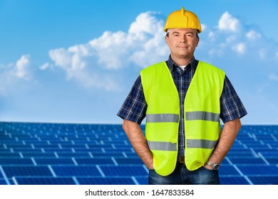 Senior Engeneer In Worker Helmet On Solar Panels Background.