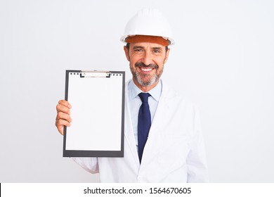 Senior engineer man wearing security helmet holding clipboard over isolated white background with a happy face standing and smiling with a confident smile showing teeth