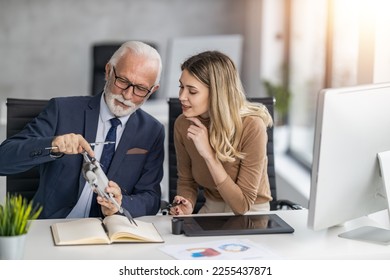Senior engineer and technician working together on new project in modern office.Engineers working on drone in office. - Shutterstock ID 2255437871