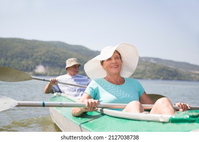  senior enjoying the day on the lake. Senior couple enjoying kayaking on the river. Social Distancing. Digital detox. Staycations, hyper-local travel, family outing, getaway. - Powered by Shutterstock