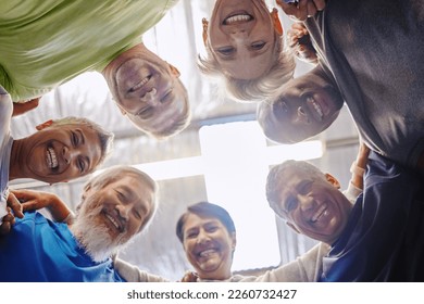 Senior exercise group, teamwork circle and low angle portrait with smile, diversity and support for health. Elderly fitness, team building and solidarity for happiness, hug or motivation for wellness - Powered by Shutterstock