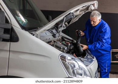 Senior Experienced Mechanic Repairing A Car