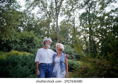 Senior Family Couple Walking Together At Summer Park.