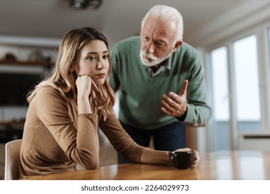 Senior father  arguing with his  adult daughter at home - Powered by Shutterstock